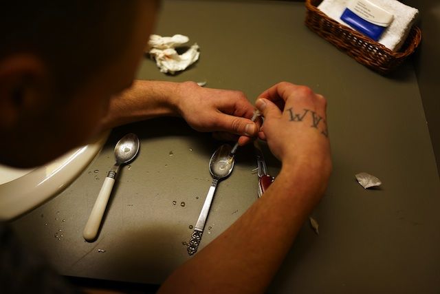 Drugs are prepared to shoot intravenously by a user addicted to heroin on February 6, 2014 in St. Johnsbury Vermont.